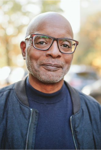 Smiling 55+ man with glasses
